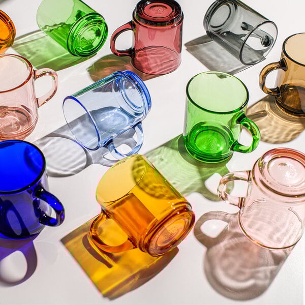 A group of grey Duralex glass mugs on a table.