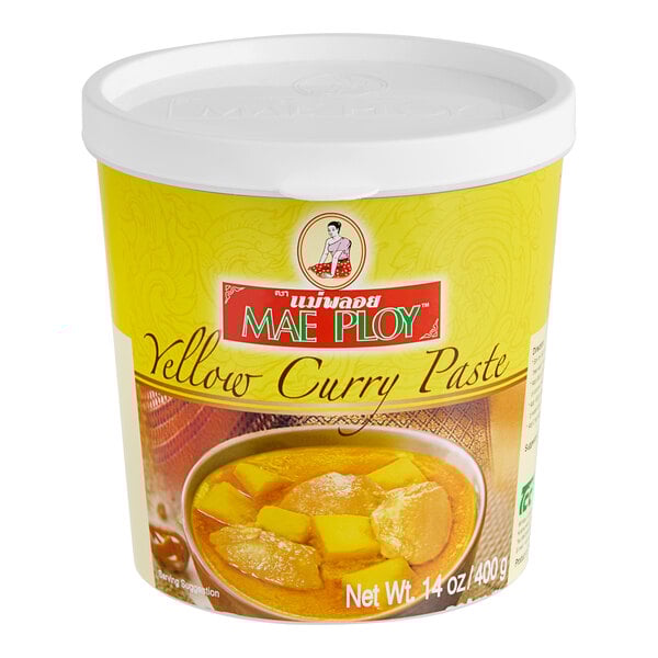 A yellow container of Mae Ploy Yellow Curry Paste with a white lid.