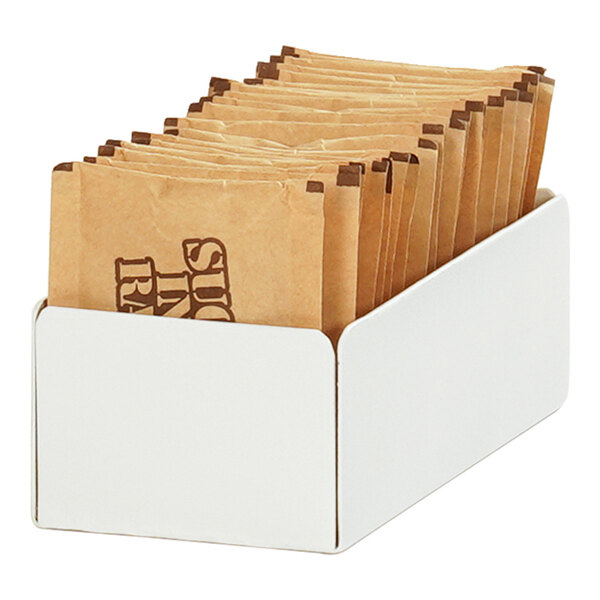 A white Cal-Mil metal box with brown paper bags in it.