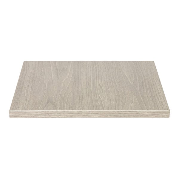 An Eastern Tabletop white rectangular high-pressure laminate riser shelf on a white wood surface.