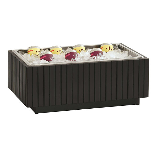 A black wooden ice housing with cans of soda in it.