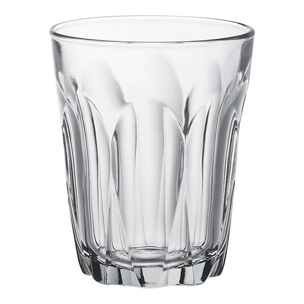 A clear glass tumbler with a curved design.