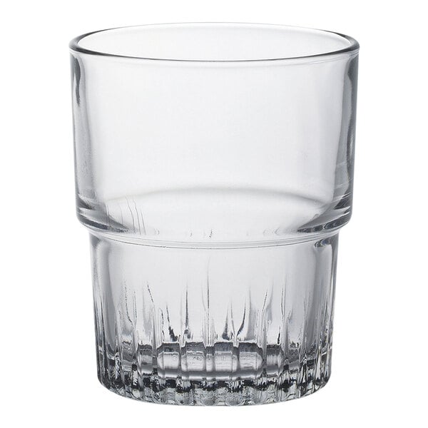 A clear Duralex glass tumbler with a white rim.