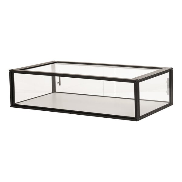 A black metal Cal-Mil bakery display case on a glass table.