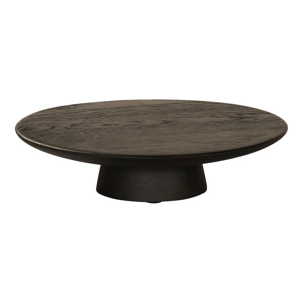 A round wooden table with a black Cal-Mil cake pedestal on top.