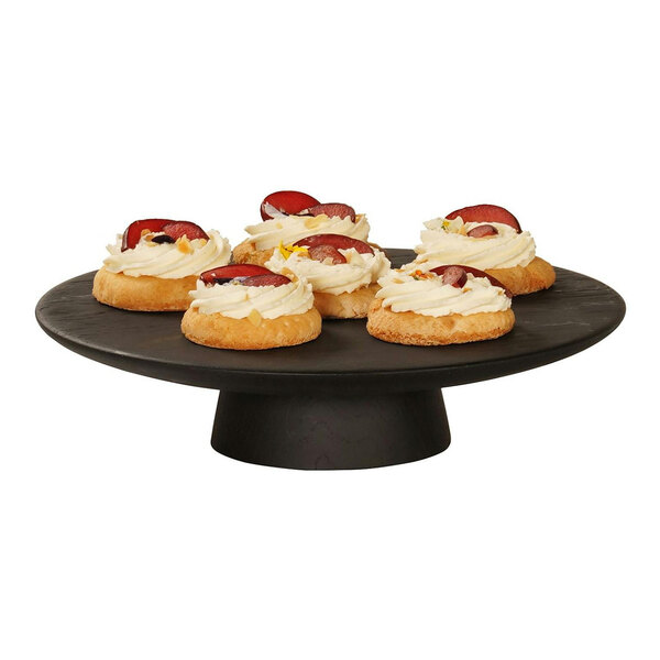 A black Cal-Mil cake pedestal with four small cakes on it.