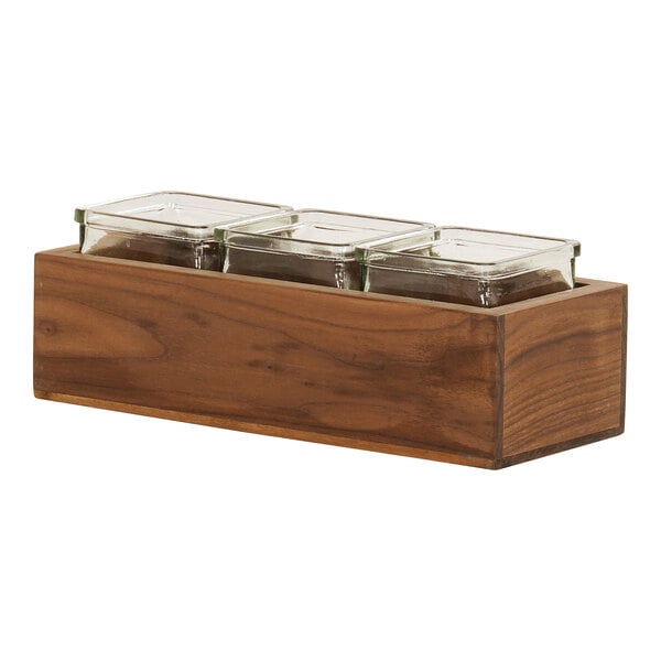 A walnut wooden box with three square glass containers inside.