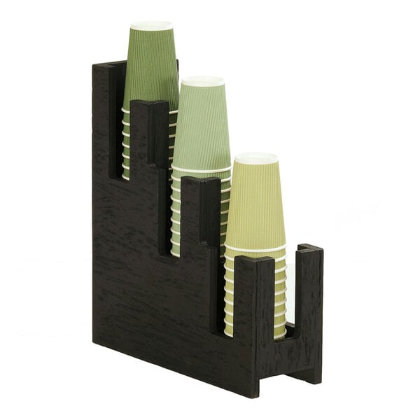 A black holder with several cups on it.