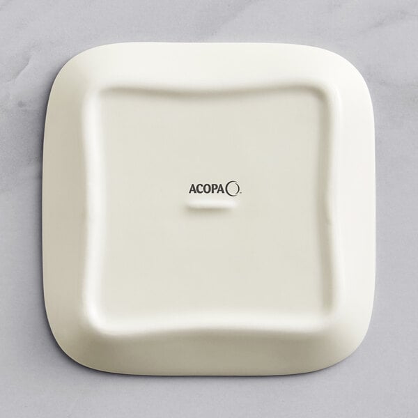 A white square Acopa porcelain butter dish with black text reading "Acopa" on the lid.