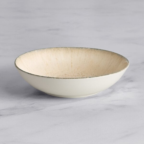 An Acopa Cape gray porcelain deep coupe plate with a white rim.