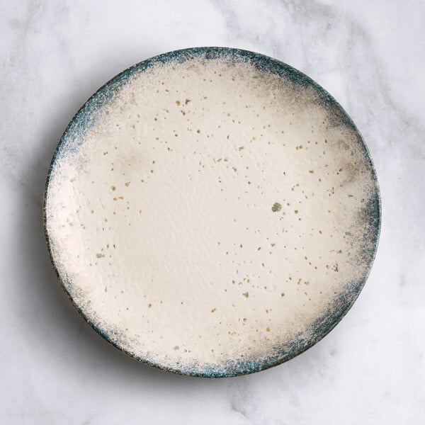 A round gray porcelain coupe plate with a speckled design and a slightly textured surface.