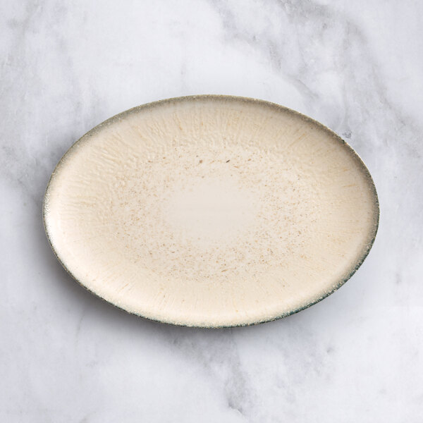 An Acopa Cape oval gray porcelain platter with a brown speckled surface.