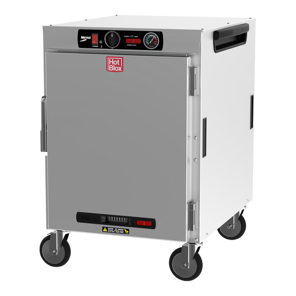 A white rectangular Metro holding cabinet with black wheels and a solid door.