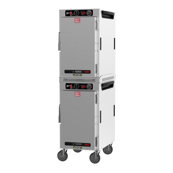 A white and black Metro heated holding cabinet with wheels.