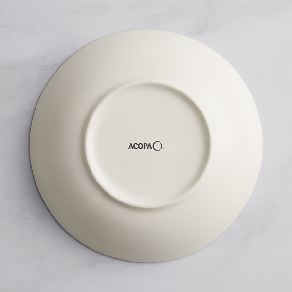 A beige porcelain deep coupe plate with black text on it.