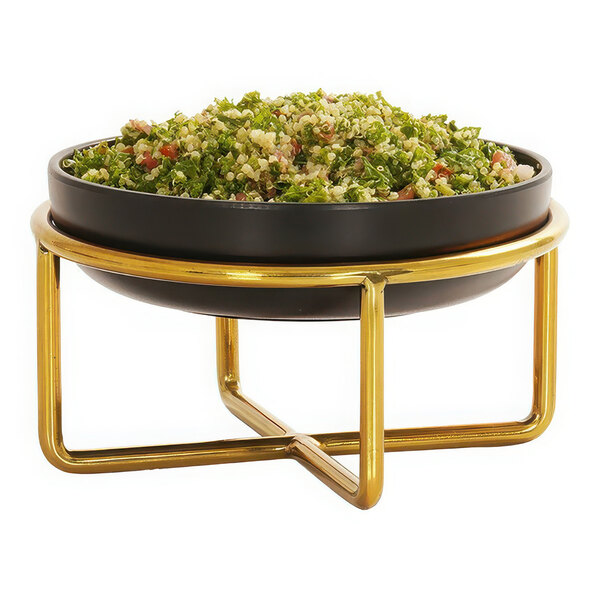 A bowl of green salad on a Cal-Mil brass wire riser.