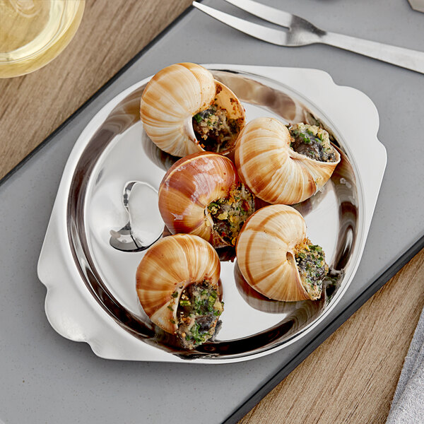 A stainless steel dish with six wells, each holding a stuffed escargot shell.