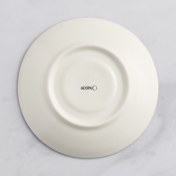 A gray porcelain saucer with black text reading "Acopa Architect"