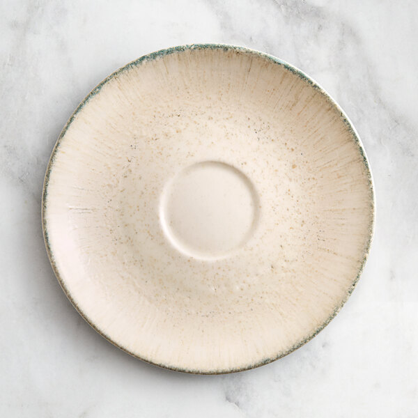 An Acopa Cape porcelain saucer with a gray border.