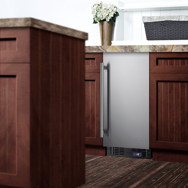 A Summit Appliance stainless steel built-in freezer under a kitchen counter.