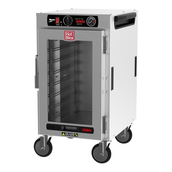 A white metal Metro holding cabinet with a clear glass door.