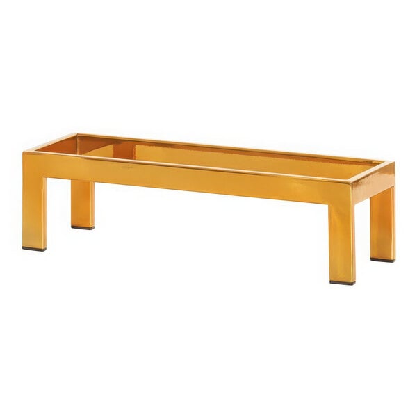 A gold rectangular Cal-Mil display riser with legs.