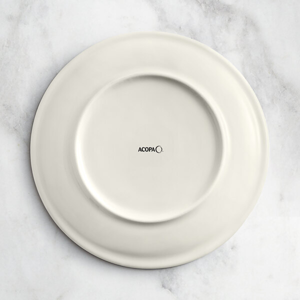 An Acopa Cape gray porcelain coupe plate with a circular design on it.