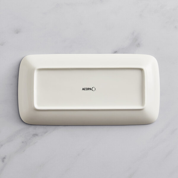 A rectangular white porcelain platter with black text on it.