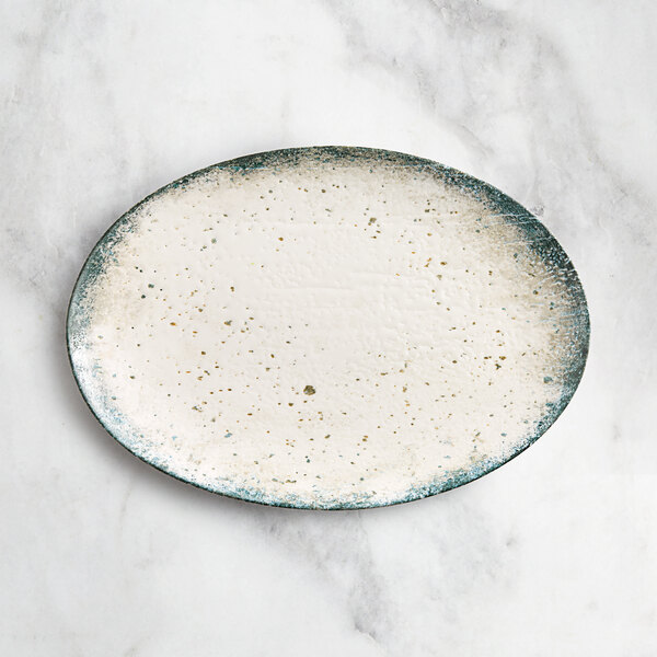 An oval gray porcelain platter with a speckled design.