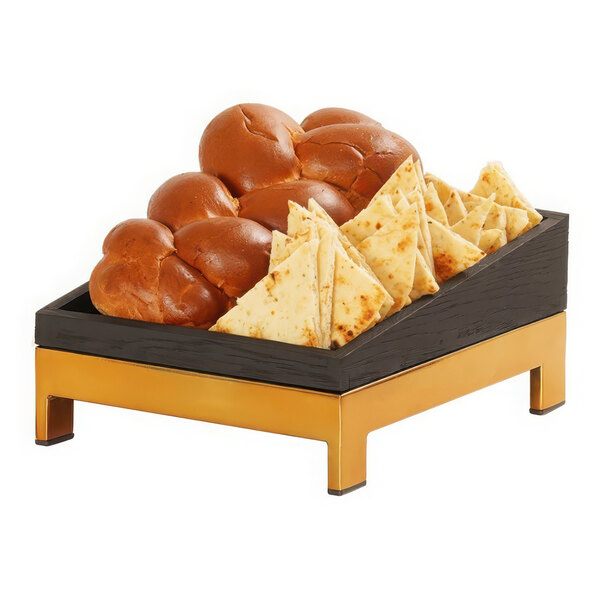 A Cal-Mil brass metal display riser with bread and cheese on it.