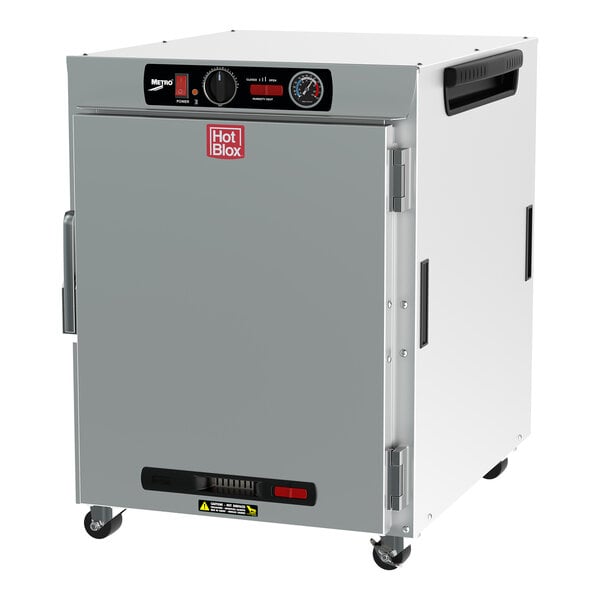 A wide white rectangular insulated holding cabinet with a solid door and analog controls.