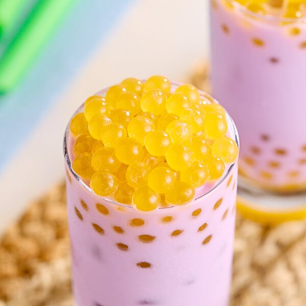 A spoon full of yellow Fanale Mango Popping Boba.