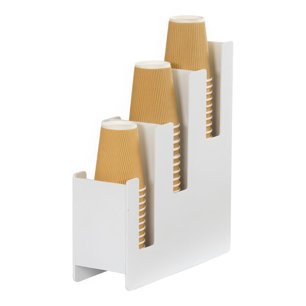 A white plastic cup holder with three stacked paper cups in it.