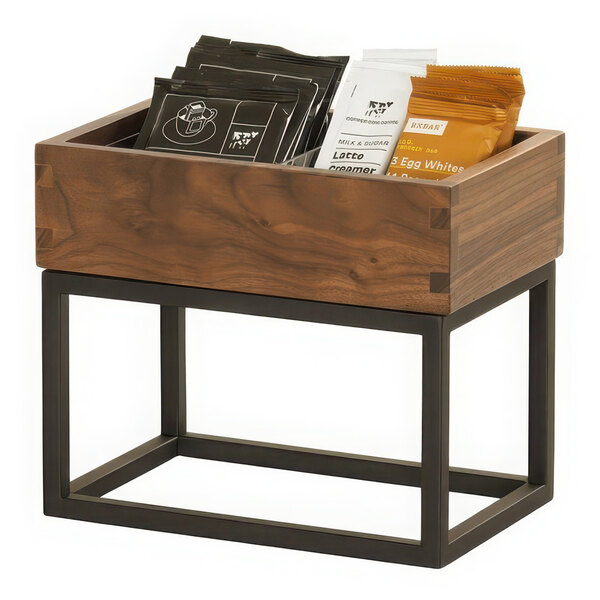 A wooden box with bags of coffee on a table.