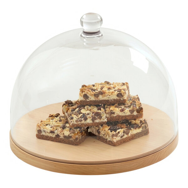A group of brownies on a wooden tray with a Cal-Mil Sydney round blonde display stand.