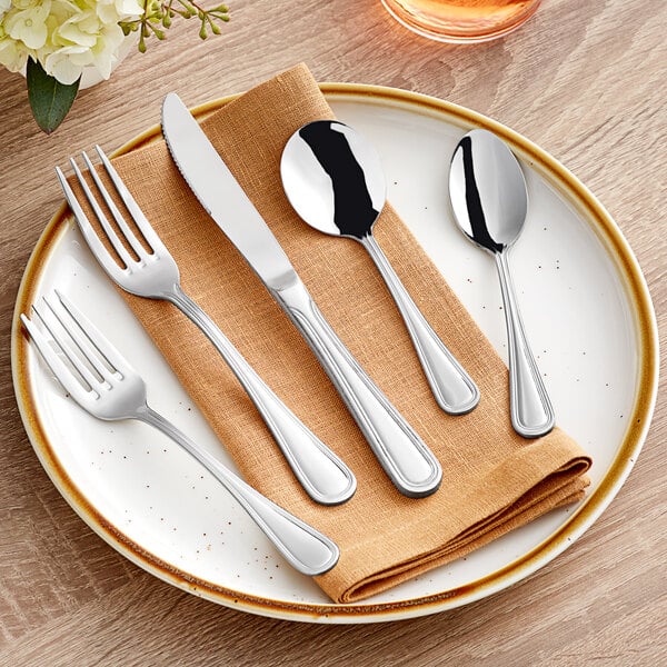 Acopa flatware on a plate with a fork and knife.