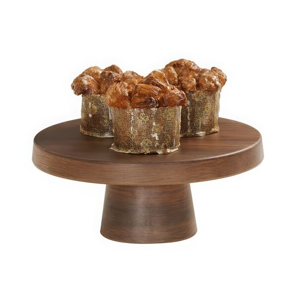 A Cal-Mil walnut melamine cake pedestal holding muffins on a wooden table.
