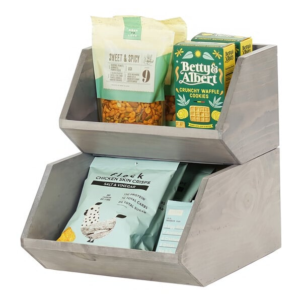 A wooden counter display with snacks inside.