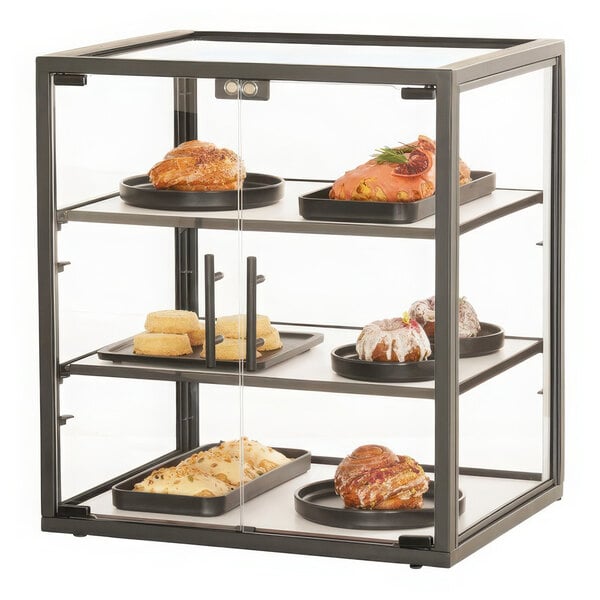 A metal 3-tier display case with pastries on it.
