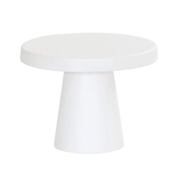 A white round melamine cake pedestal with a round top on a white table.