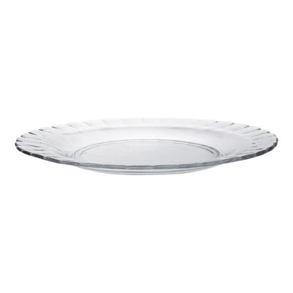 A close up of a Duralex clear glass plate with a rippled rim.