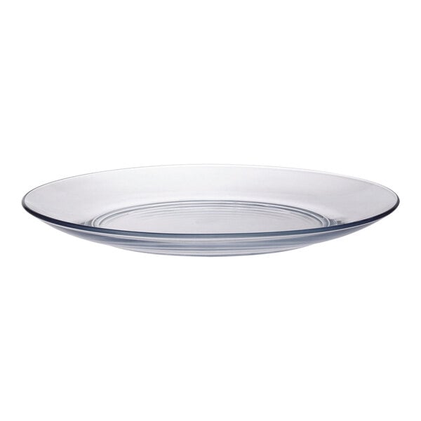 A close-up of a clear glass plate with a clear rim.
