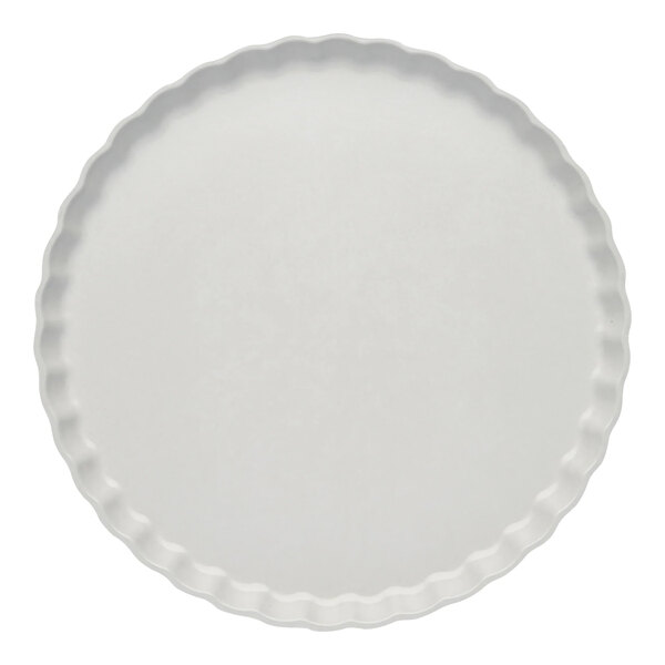 A white Sophistiplate Simply Eco salad plate with a scalloped edge.