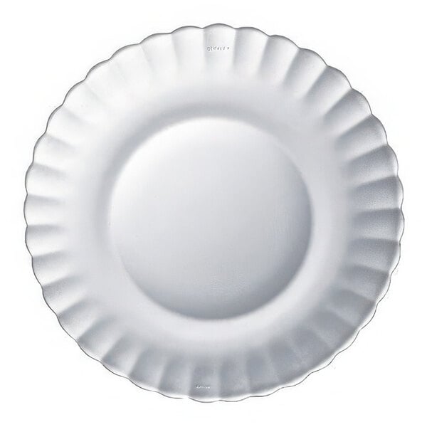 A clear glass dinner plate with a scalloped edge.