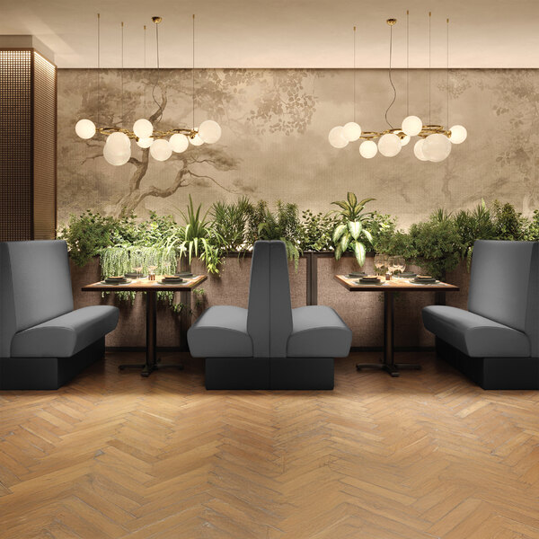 A graphite-colored single back booth with a plain design and a 36-inch high backrest, placed in a modern restaurant setting.