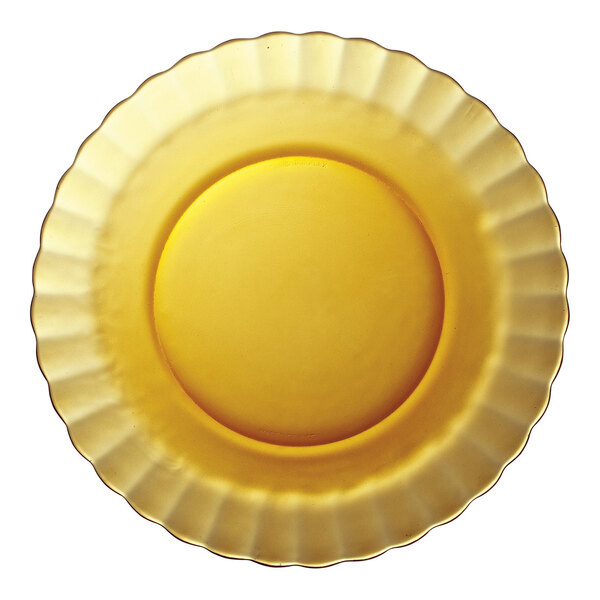 A close-up of a yellow Duralex Picardie glass plate with a scalloped edge.