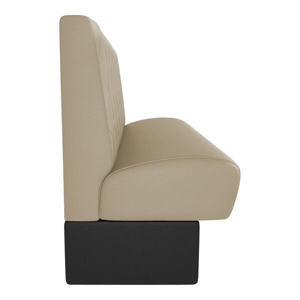 A tan leather tufted booth with black legs.