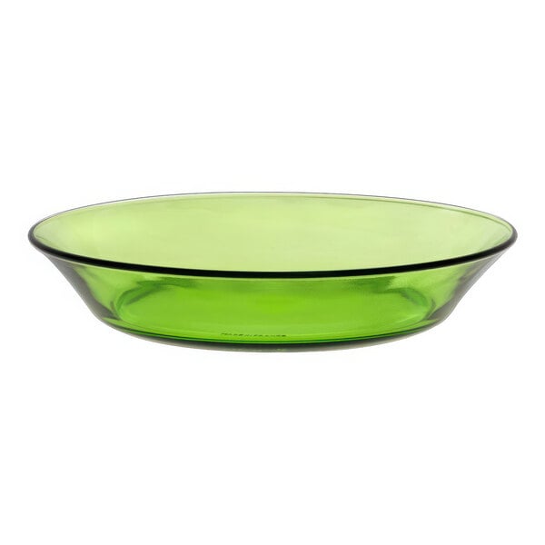 A close up of a Duralex green glass soup plate with a black rim.