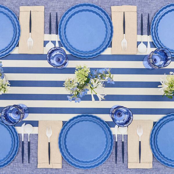 A table set with Sophistiplate Simply Eco French Blue salad plates and silverware.