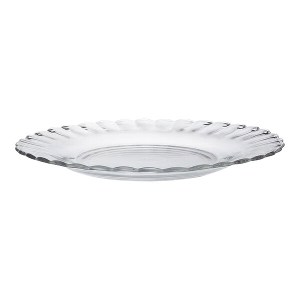 A clear glass Duralex dessert plate with a scalloped edge.
